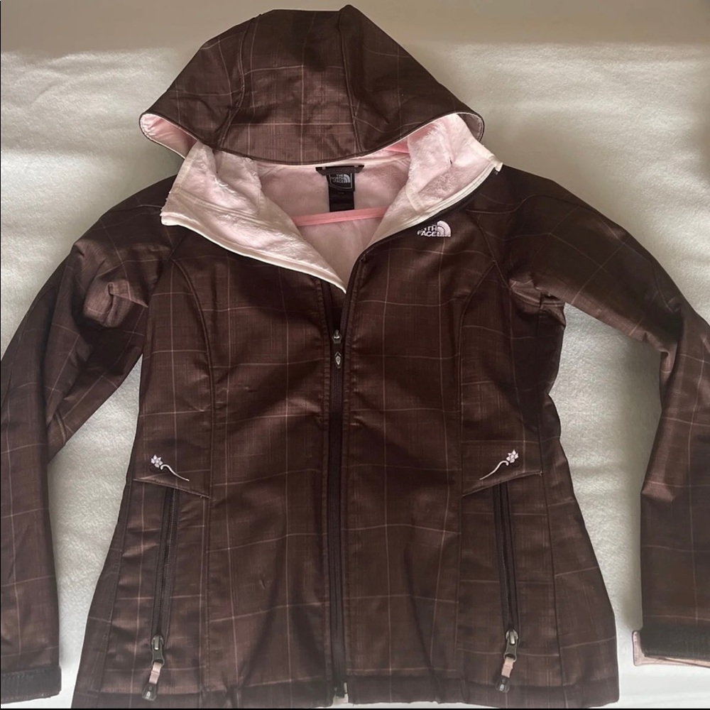 The North Face size Medium dark brown jacket with light pink plaid. Like-new.